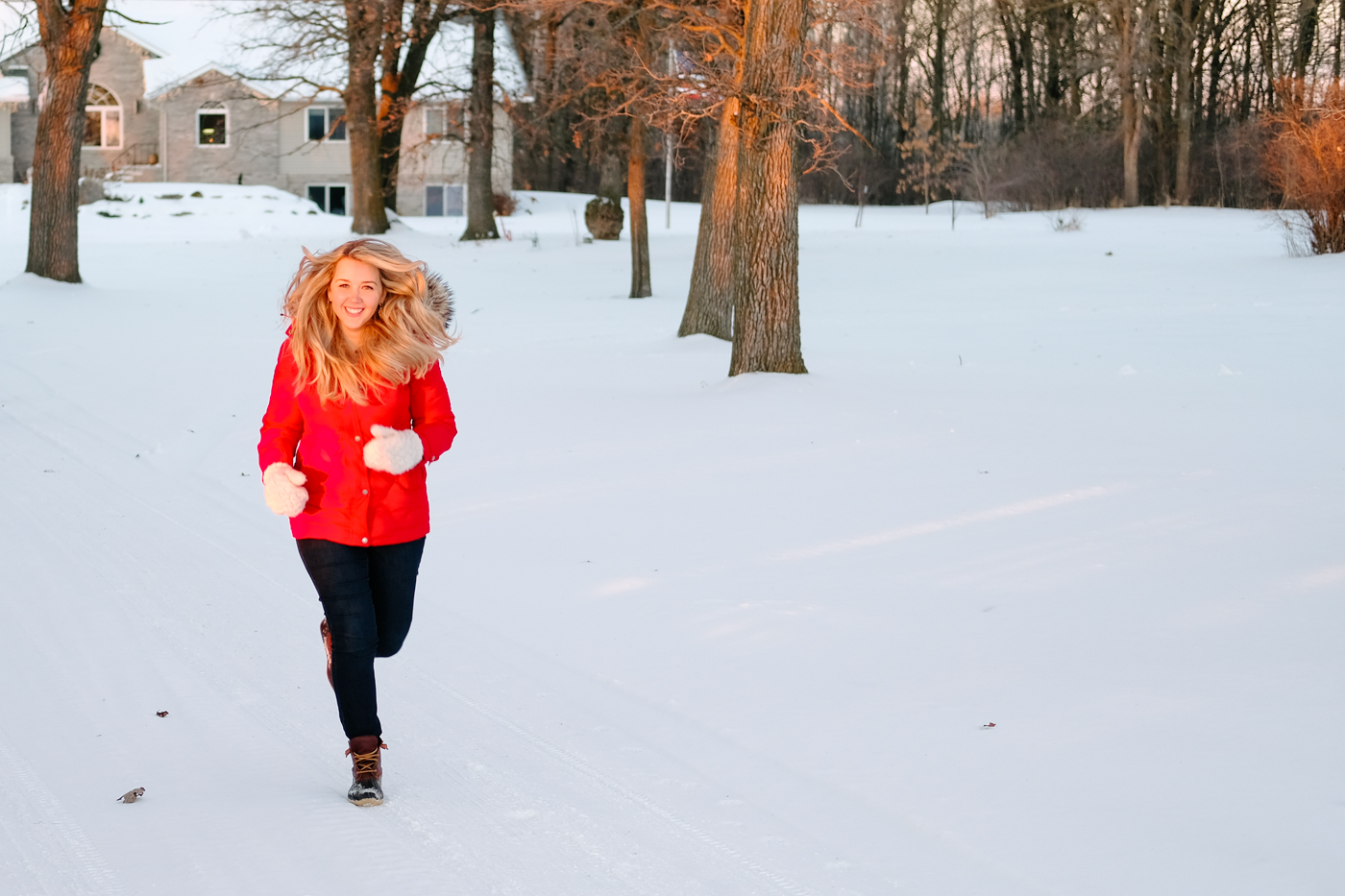 Debora Dahl running in the snow with hair blowing in the wind