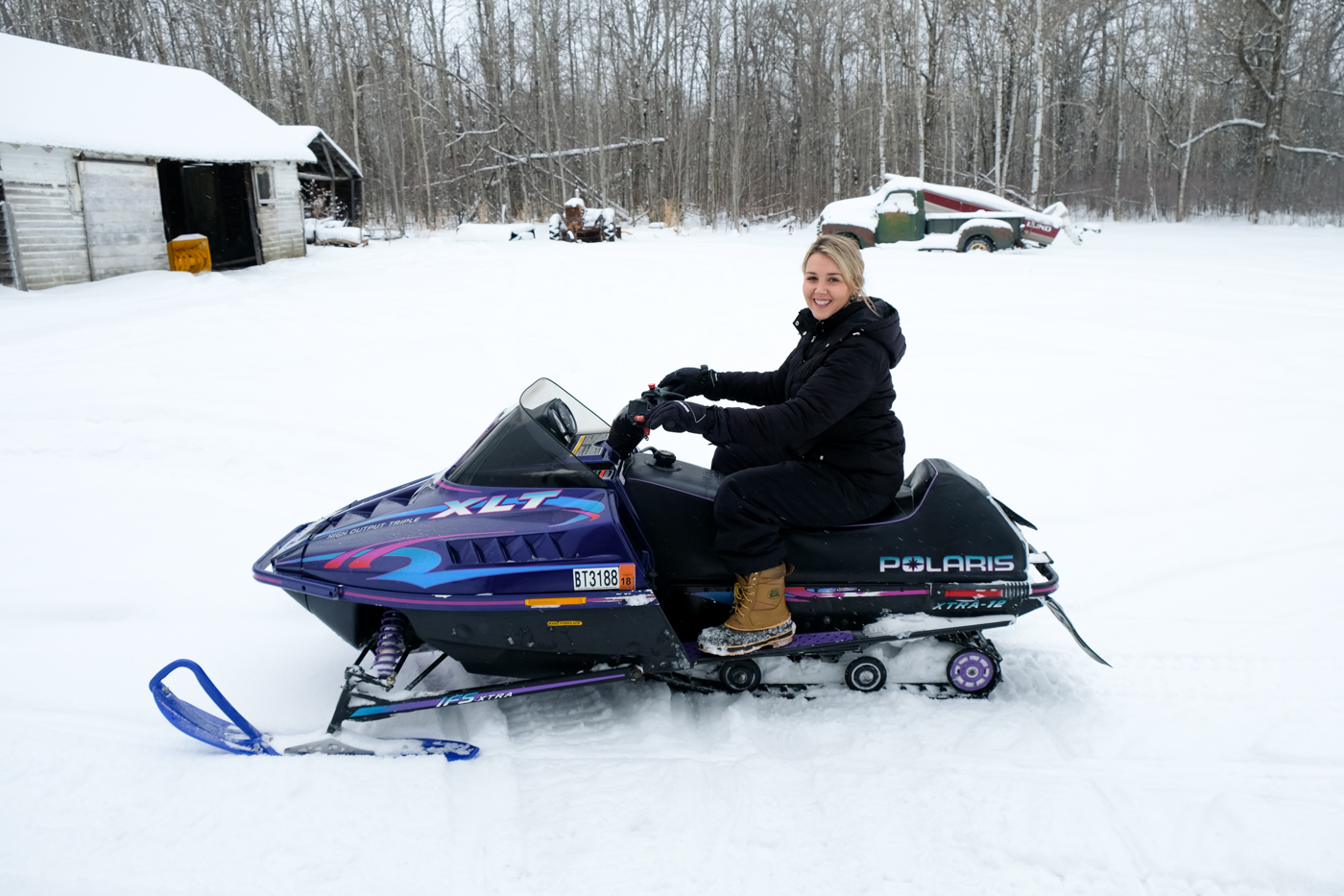 Debora Dahl playing in the snow in the snowmobile