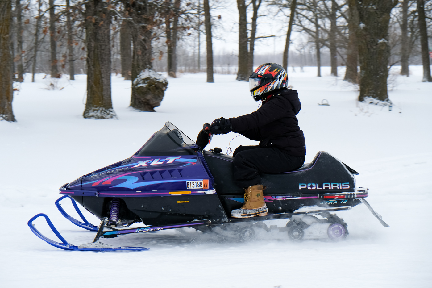 Debora Dahl playing in the snow in the snowmobile