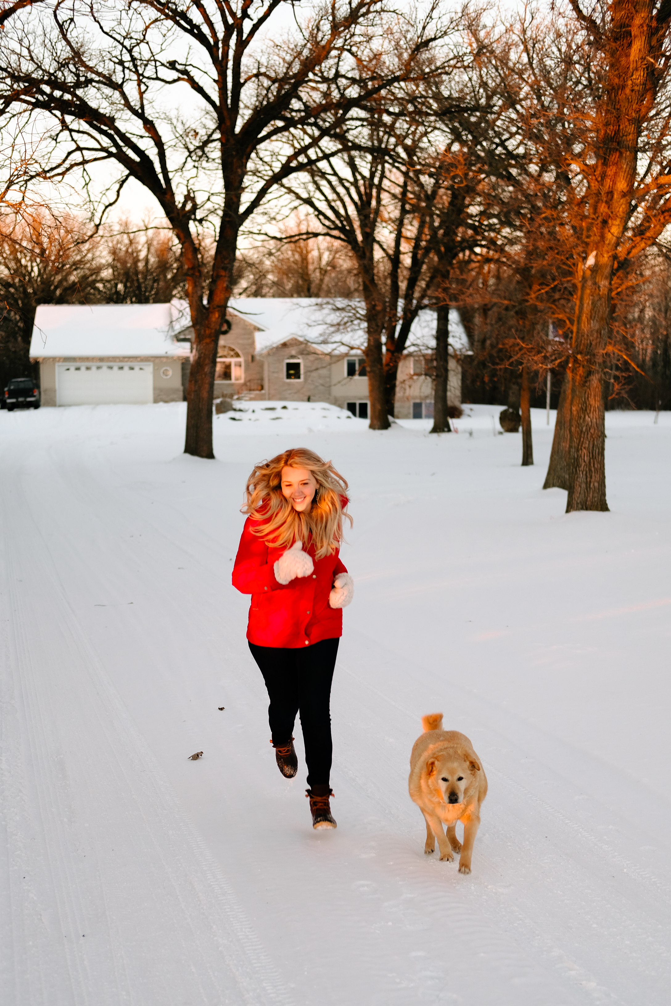 Debora Dahl running in the snow with a dog