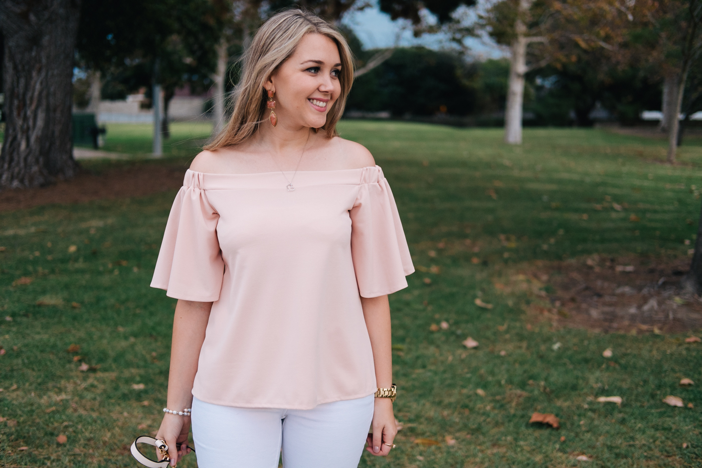 Debora Dahl wearing a pink off the shoulder white blouse from dresslily