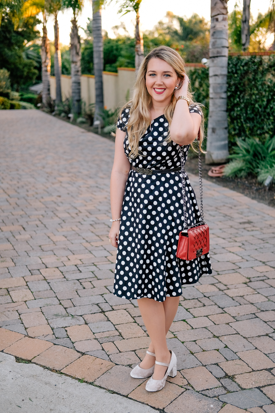 Debora Dahl black polka dor dress red purse